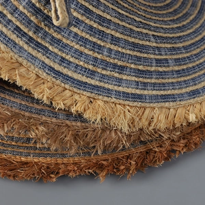 Denim and raffia sun hat with wide frayed brim and blue striped bohemian woven texture