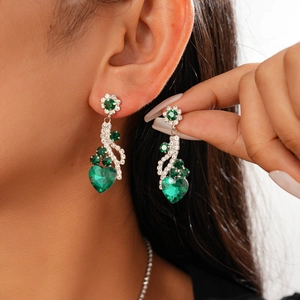 Elegant silver earrings with green heart-shaped gemstones and floral diamond accents