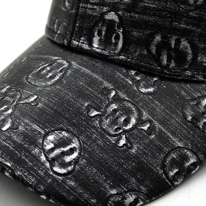 Distressed black PU leather baseball cap with 3D skull and crossbones embossing detail
