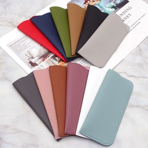 Close-up of colorful thick faux leather sunglasses pouches in a minimalist fan arrangement