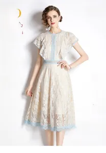 Detailed view of light blue lace dress with floral embroidery and ruffle sleeves