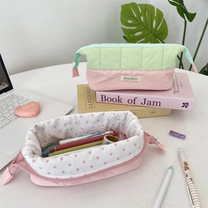 Close-up of quilted fabric pencil case featuring star lining and durable zip closure