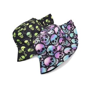 Detailed flat lay of skull print bucket hats in neon green and gradient blue styles