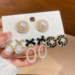 Detail view of floral pearl earring set with rhinestone accents and vintage French style