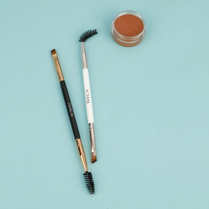 Dual-head angled eyebrow brush and spoolie set with dark brown brow pomade jars