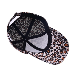 Detail of leopard print baseball cap featuring adjustable metal buckle and inner sweatband