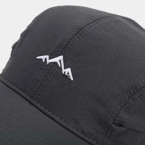 Close-up of mountain peak embroidery on quick-dry outdoor cap with fine stitching