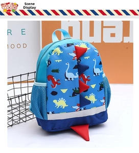 Blue dinosaur kids backpack with 3D red spikes and mesh side pocket detail view