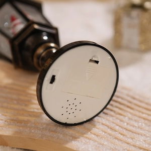Detail view of the battery compartment and switch on vintage golden Christmas lantern base