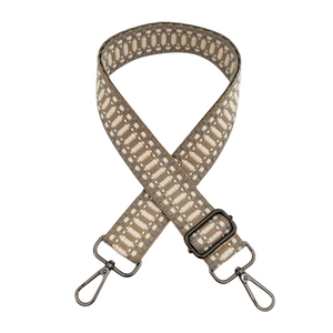 Macro detail of the woven geometric texture and dark metal hook on this wide shoulder strap