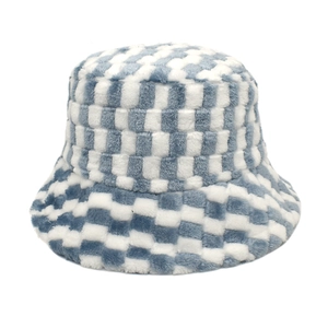Close-up of blue and white checkerboard faux fur texture on a winter bucket hat