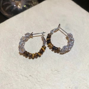 Detailed top view of 18k gold plated tiger eye stone earrings with zircon stones