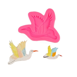 Detailed pink silicone crane mold showing intricate feather textures and finished bird crafts