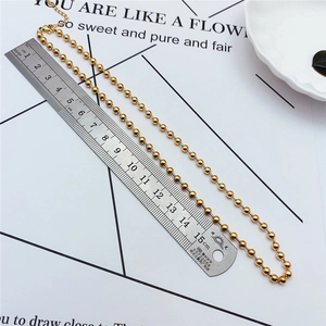 Detail showing 15cm golden ball chain length with lobster clasp and extension