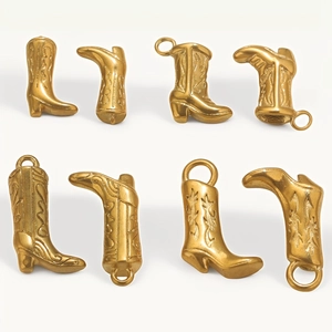 Macro detail of eight 18K gold-plated western boot charms with retro star engravings