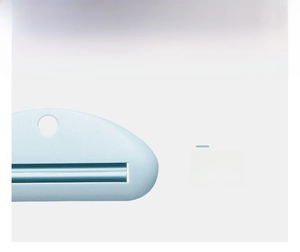 Macro shot of light blue toothpaste squeezer showing smooth finish and narrow slot