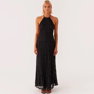 Close-up of black pleated texture on the halter neck backless long dress for women