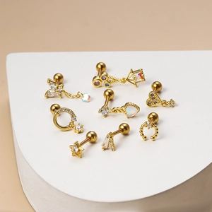 Golden stainless steel stud earrings set with crystal butterflies and heart shapes