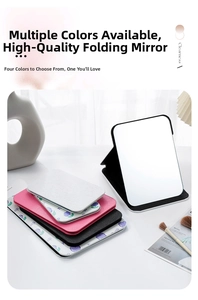 Close-up of portable PU leather folding makeup mirrors in four colors with floral pattern