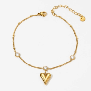 Golden stainless steel heart anklet with zircon accents on a clean white background