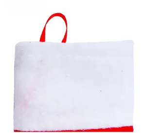 Detailed close-up of fluffy white plush fabric and red strap on Christmas cutlery holder