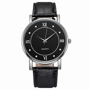 Detailed view of large black watch face with roman numerals and crocodile leather strap