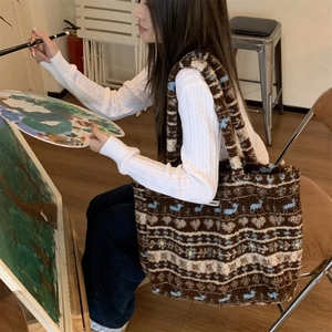 Detail of plush brown tote bag with vintage flower patterns in an artistic setting