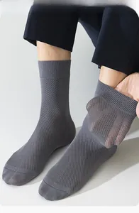 Close-up of men's dark grey mesh business socks showing honeycomb breathable texture