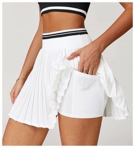 Detail of white pleated tennis skort featuring breathable inner shorts with a side pocket