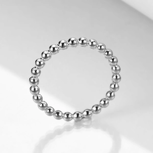 Macro shot of 2mm silver bead ring made of polished stainless steel with smooth reflection