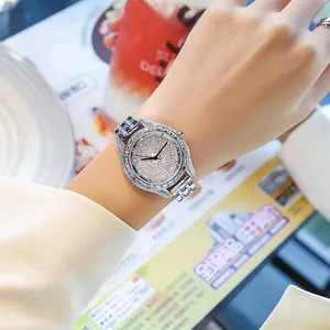 Detail shot of luxury quartz watch with silver pavé diamonds and blue gemstone accents