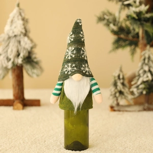 Knitted gnome wine bottle cover with green snowflake hat and striped arms for Christmas décor