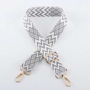 Macro view of geometric jacquard shoulder strap with gold-plated swivel lobster hooks