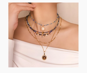 French vintage beaded necklace with devil's eye pendant shown on a female model