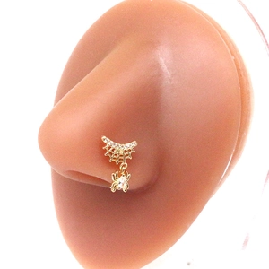 Gold spider web nose stud with clear zircons shown on a realistic nose model