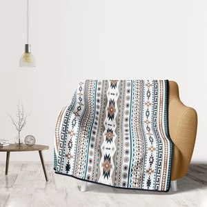 Detail of bohemian Aztec pattern flannel blanket draped over a yellow sofa chair