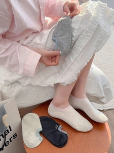 Close-up of breathable cotton no-show socks featuring elegant bow embroidery detail