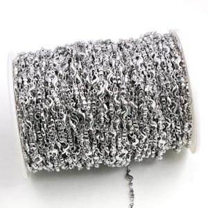 Polished stainless steel S-shaped wavy link chain on white spool for DIY jewelry making