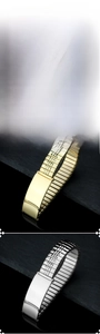 Detail showing elastic stainless steel watch bands in black, silver, and gold finishes