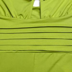 Detailed macro shot of green jumpsuit waist with elastic pleated fabric and stitching