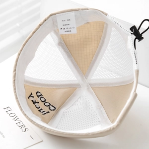 Detail view of the breathable white mesh lining and lucky good embroidery on baby sun hat