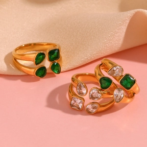 Detail of 18K gold plated double layer rings with green and clear zircon gemstones