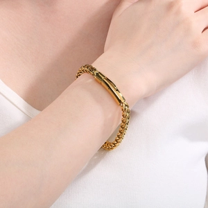 Minimalist gold stainless steel chain bracelet for men worn on a model's wrist