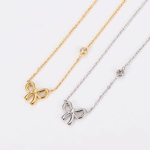 Elegant gold and silver stainless steel bow pendant necklaces with diamond accents