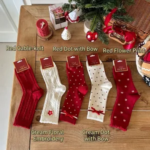 Thick warm red and white Christmas socks with festive bow details and floral patterns