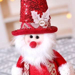 Detail of Santa Claus plush with red sequins, fuzzy beard and festive gold accents