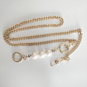 Detailed view of golden replacement chain strap with three white faux pearls and buckles