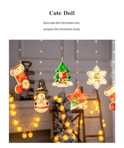 Detail of warm white LED Christmas curtain lights with snowman and star pendants