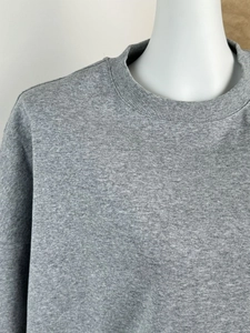 Detail of grey crewneck T-shirt showing reinforced ribbed neckline and knit texture
