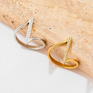 Minimalist stainless steel zircon open rings in gold and silver on a marble stone base